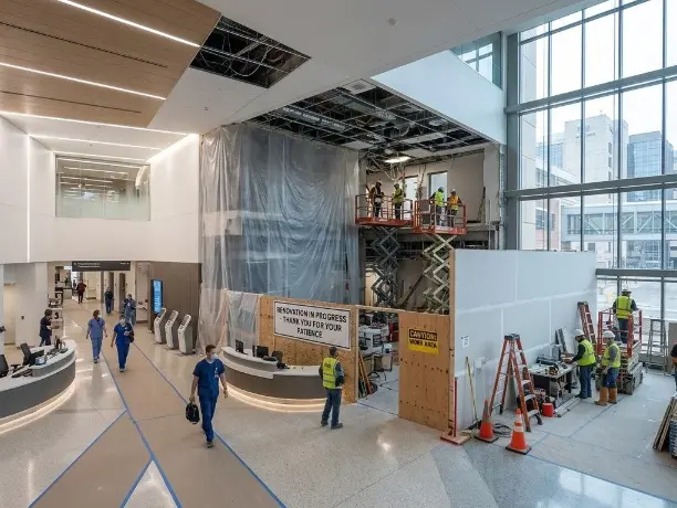 A clean, high-tech hospital lobby in Rochester undergoing renovation with LED lighting and modern architectural features.